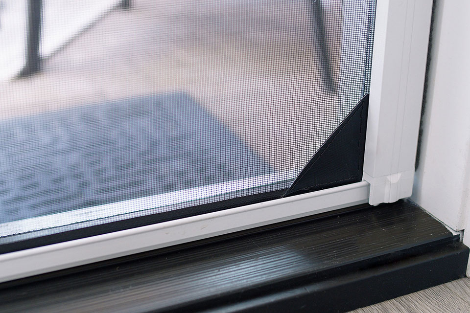 Door screen reinforced with mesh lock to keep small pets safely inside